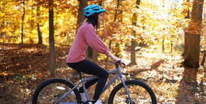 Girl biking in the forest with her 27.5" Rover Flex 27.5